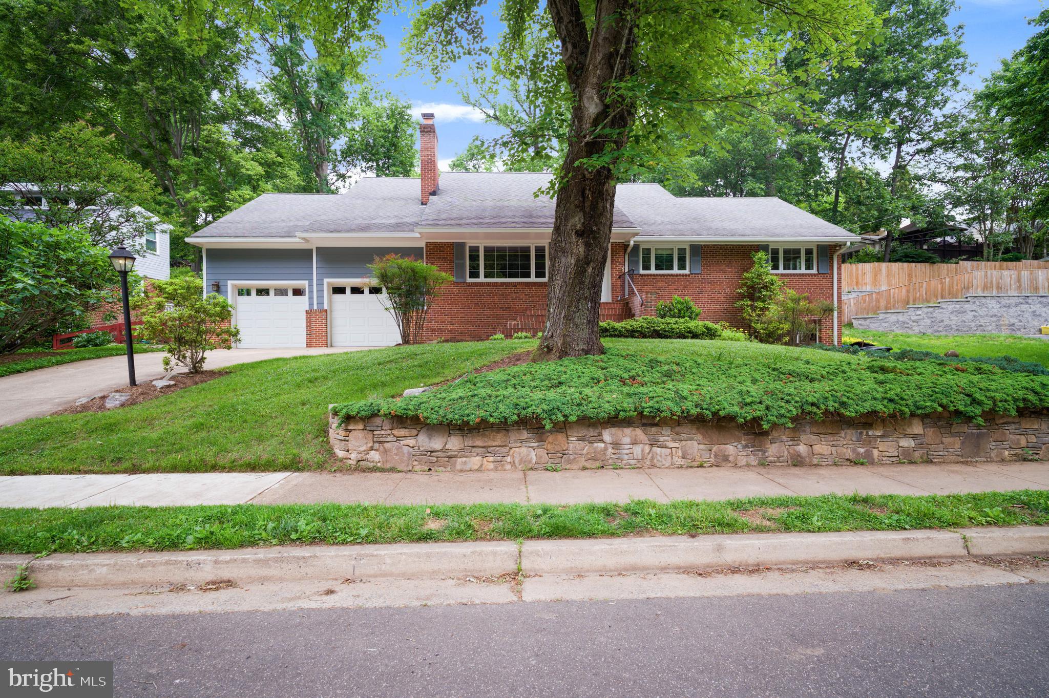 3111 North Thomas Street Arlington, VA 22207 - Photo 36 of 40 a front view of a house with a garden and deck