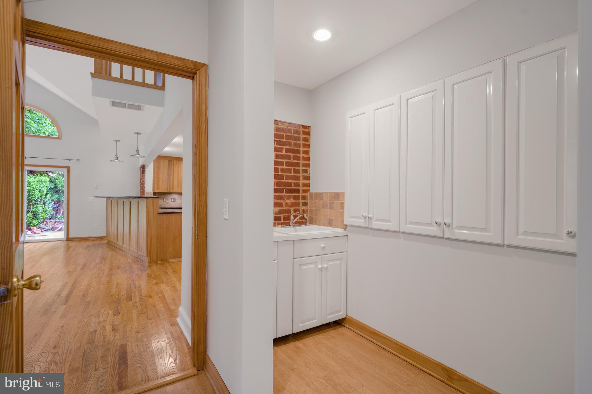 3111 North Thomas Street Arlington, VA 22207 - Photo 10 of 40 a view of hallway with livingroom and wooden floor