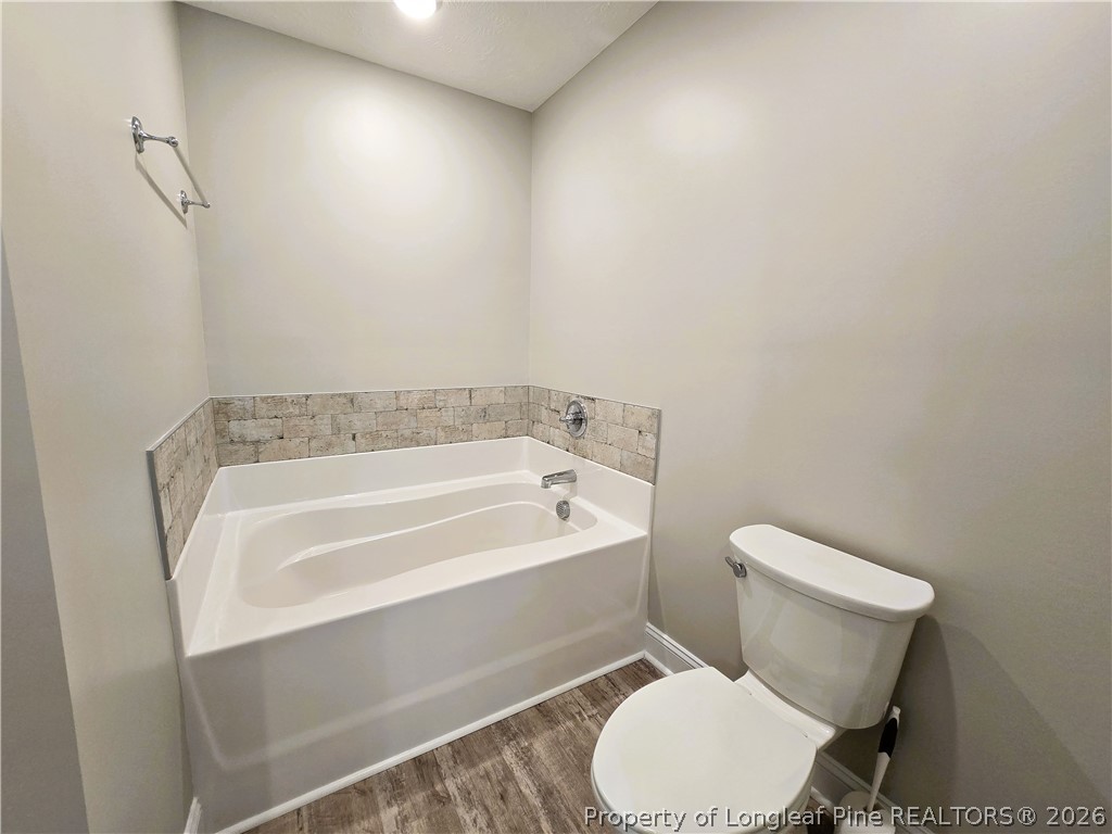 422 Mitchell Farm Road Goldsboro, NC 27530 - Photo 26 of 28 a white toilet sitting next to a bath tub