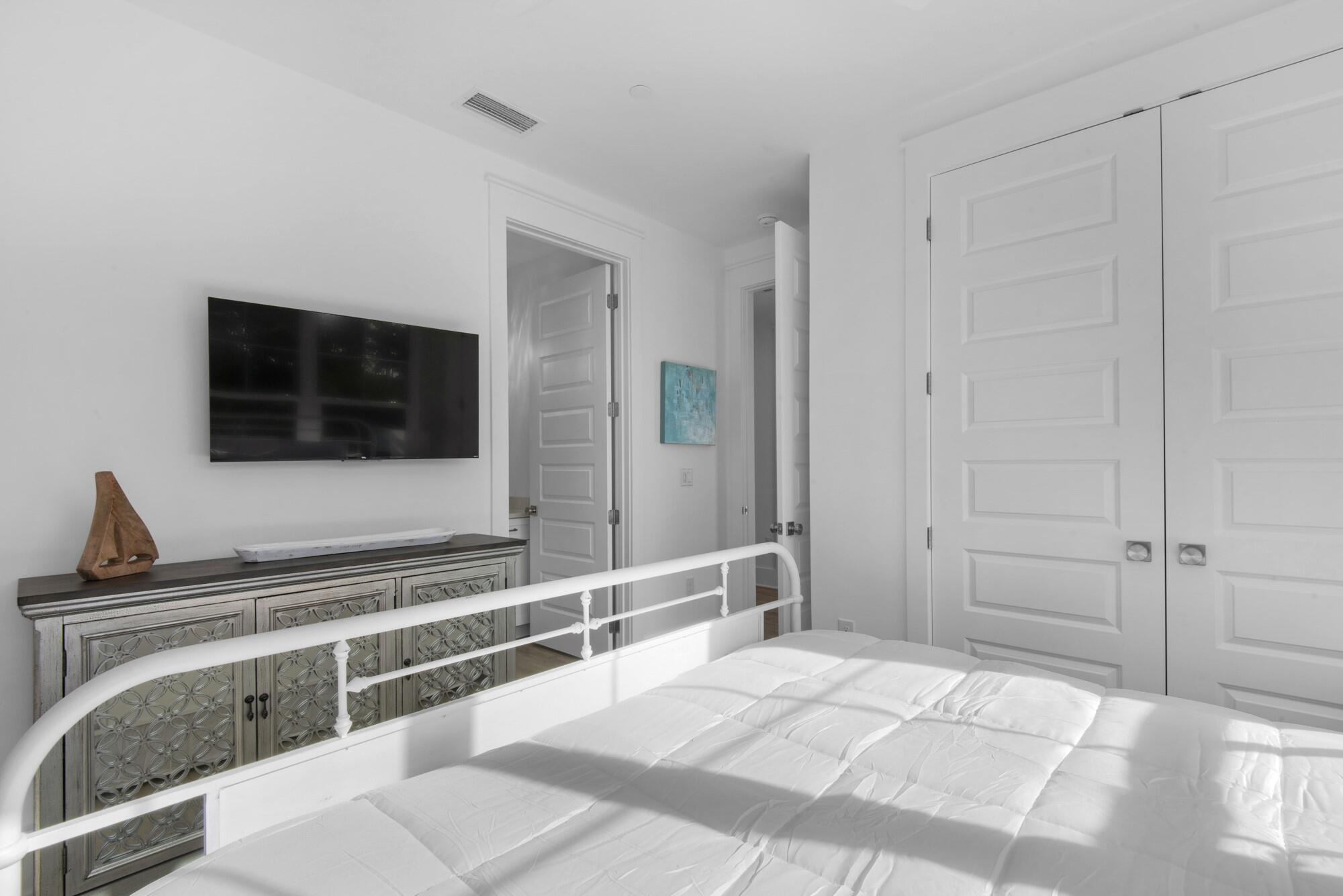 6528 West County Highway 30A Santa Rosa Beach, FL 32459 - Photo 17 of 87 a bedroom with a bed and a flat screen tv