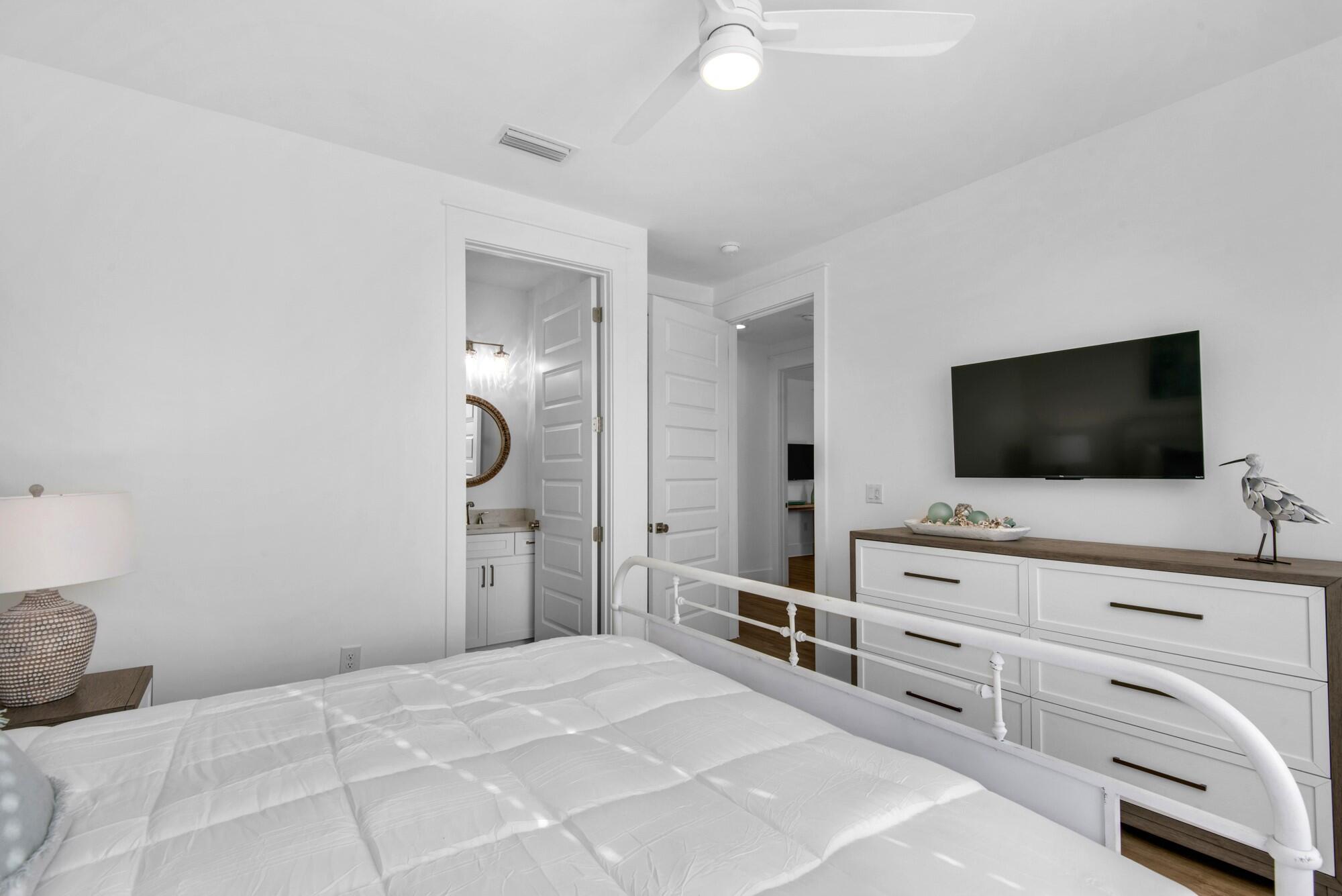 6528 West County Highway 30A Santa Rosa Beach, FL 32459 - Photo 26 of 87 a bedroom with a bed and a flat screen tv