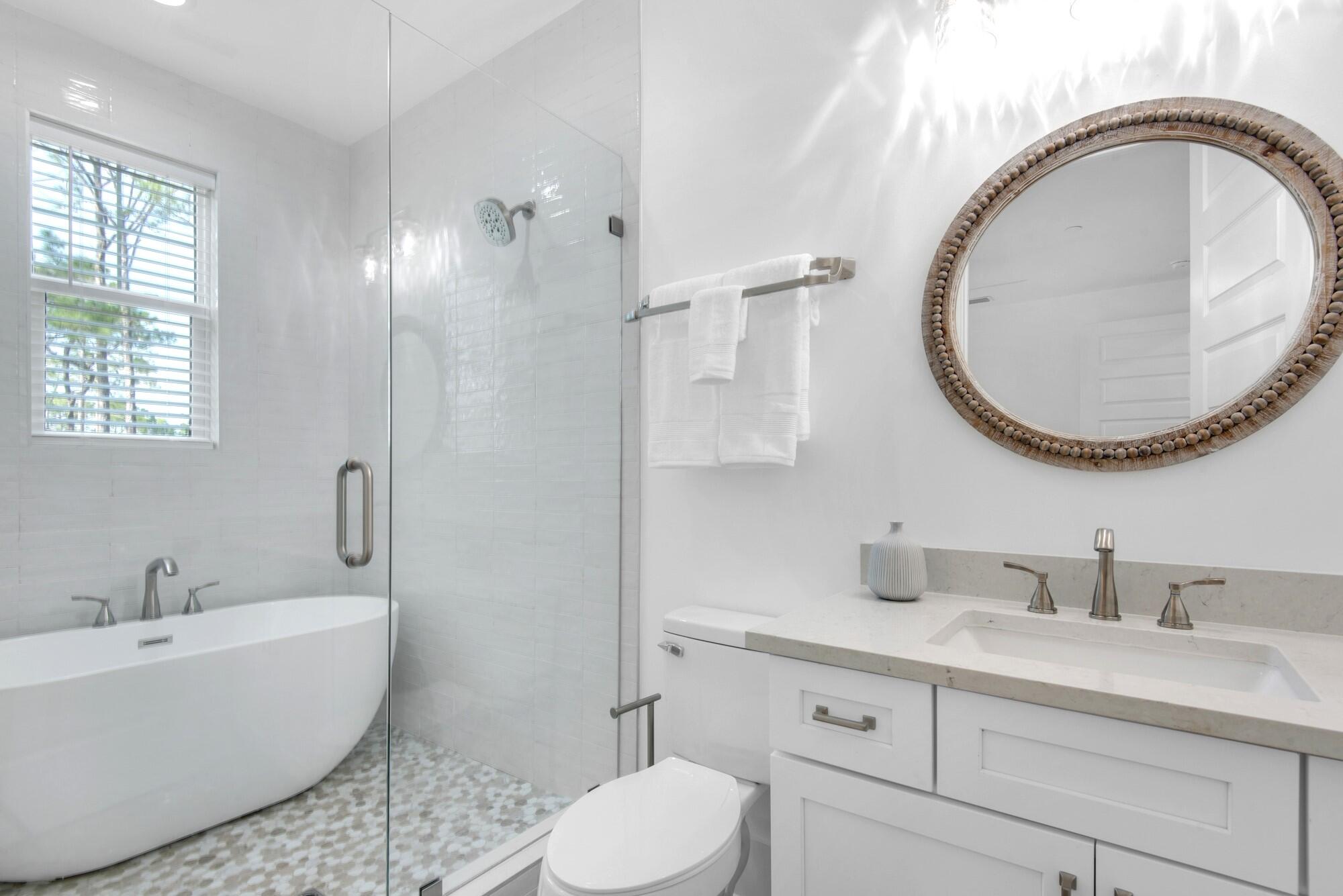 6528 West County Highway 30A Santa Rosa Beach, FL 32459 - Photo 30 of 87 a bathroom with a toilet a sink and a mirror