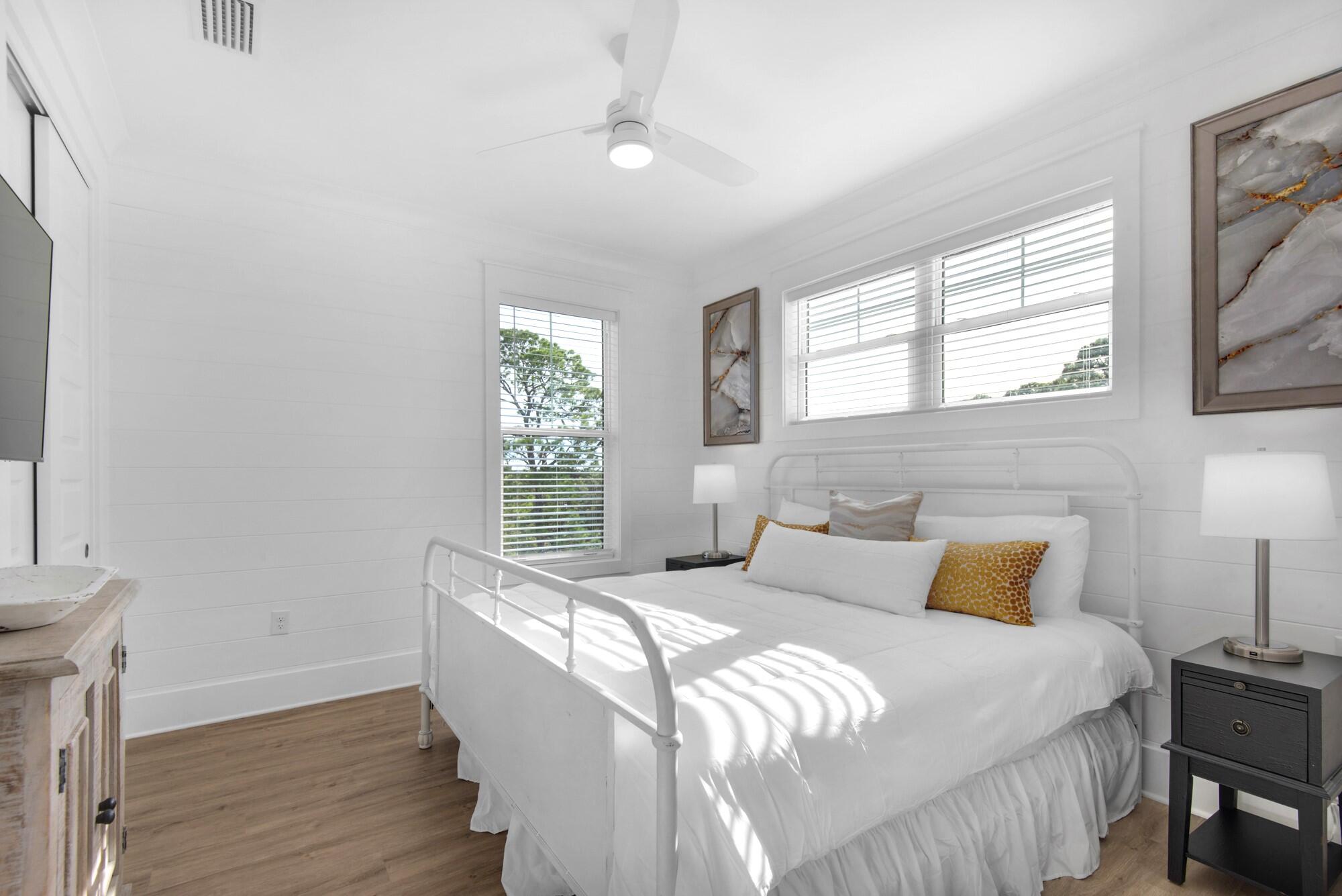 6528 West County Highway 30A Santa Rosa Beach, FL 32459 - Photo 35 of 87 a bedroom with a bed and wooden floor