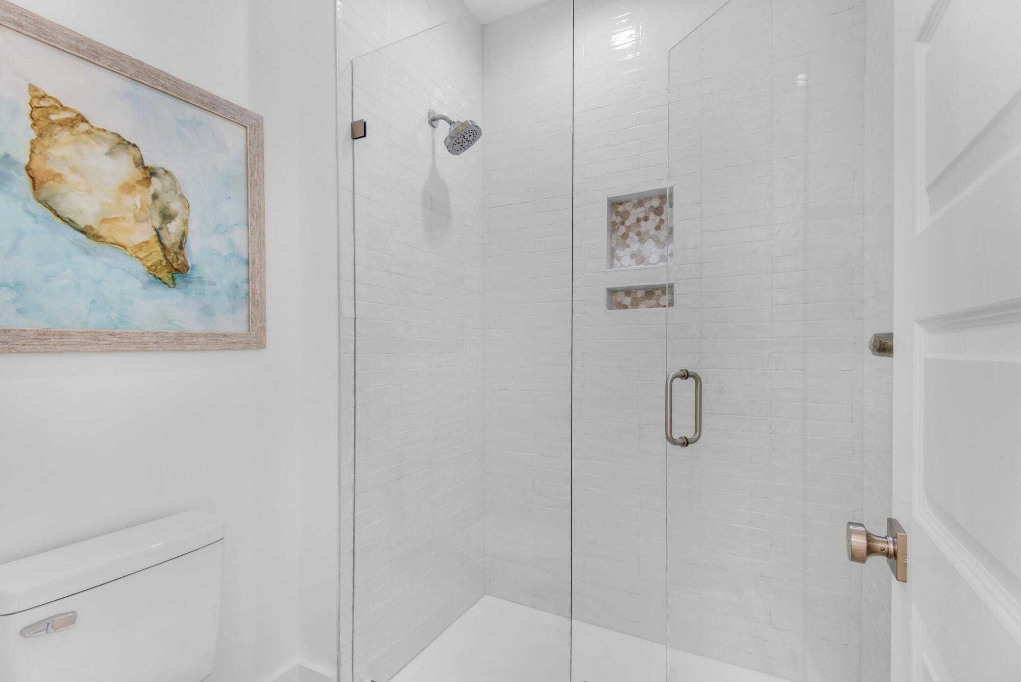 6528 West County Highway 30A Santa Rosa Beach, FL 32459 - Photo 38 of 87 a bathroom with a painting on the wall and shower