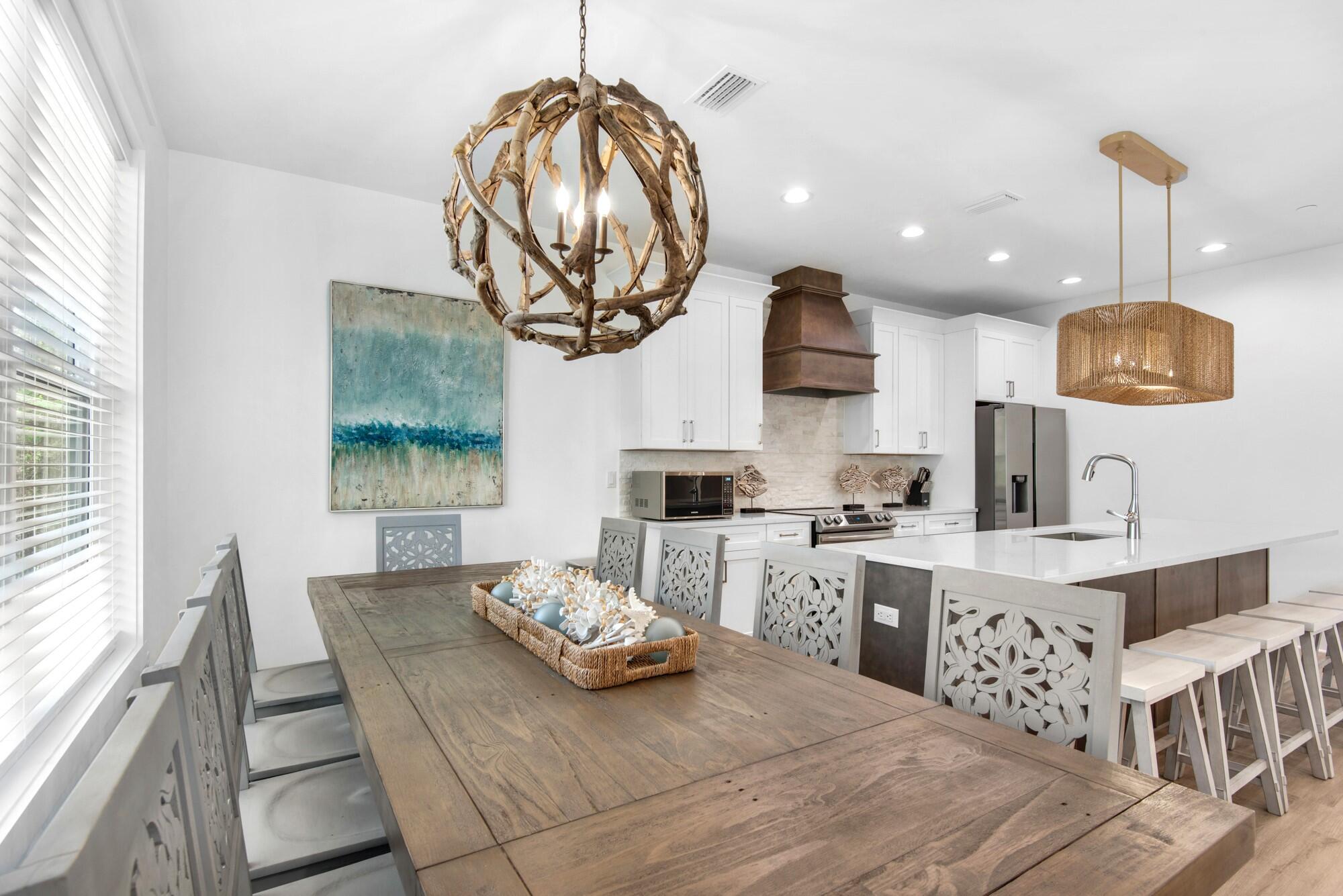 6528 West County Highway 30A Santa Rosa Beach, FL 32459 - Photo 7 of 87 a kitchen with a dining table and chairs