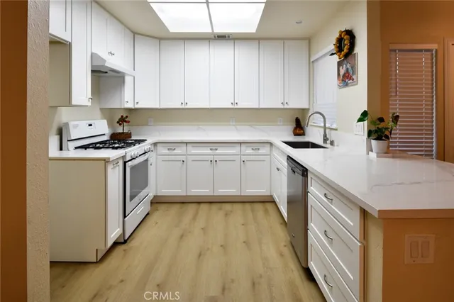a kitchen with a sink stove and cabinets
