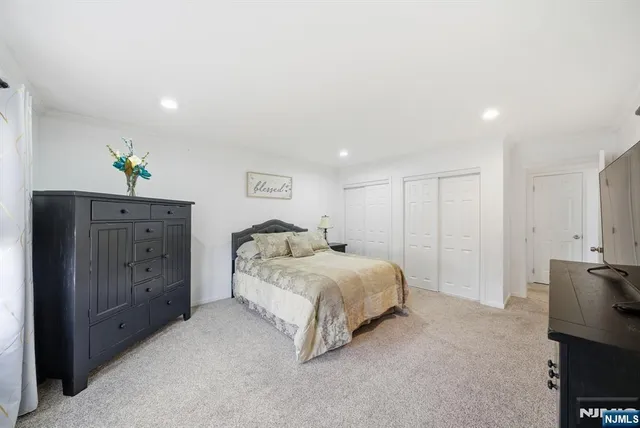 a spacious bedroom with a bed and a lamp