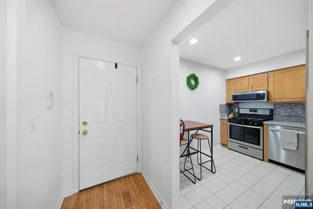 a view of kitchen with sink microwave and refrigerator