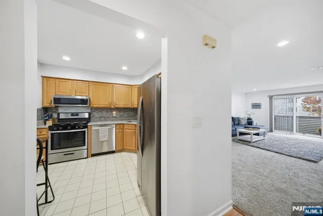 a kitchen with stainless steel appliances granite countertop a stove and a refrigerator