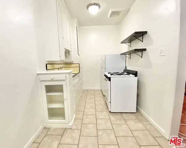 a utility room with sink dryer and washer