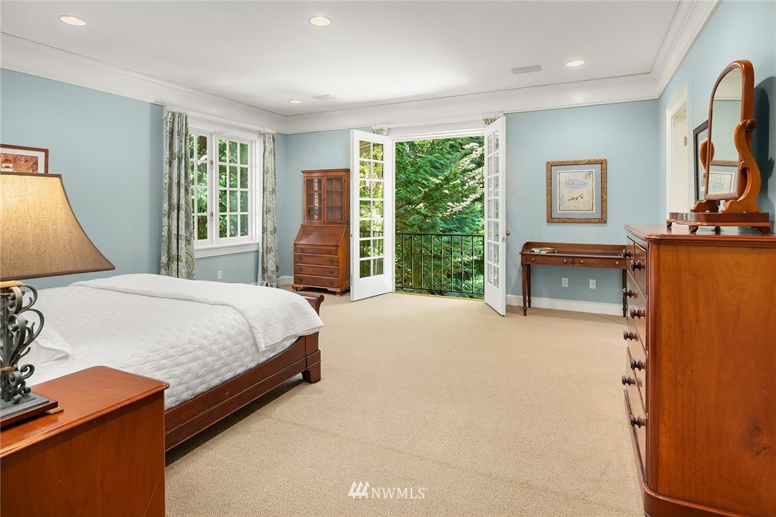 142 Moss Road Shoreline, WA 98177 - Photo 18 of 32 a bedroom with a large bed and a large window