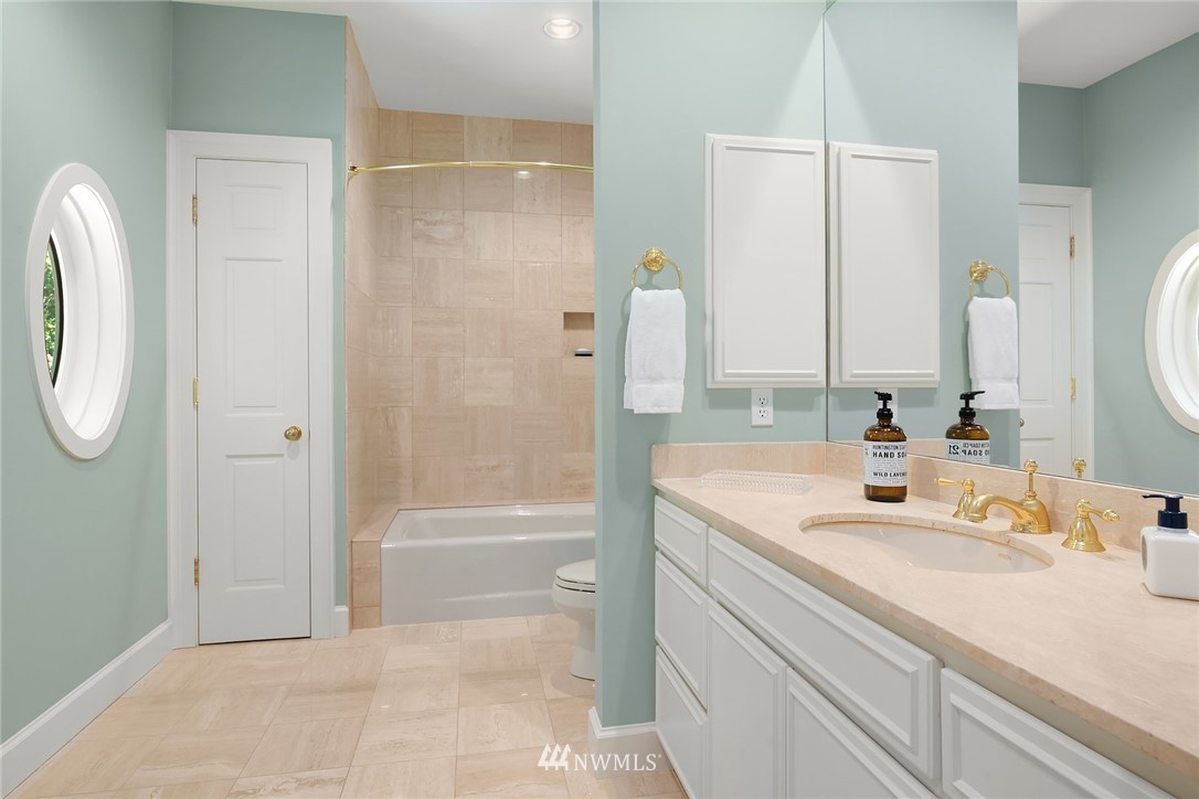 142 Moss Road Shoreline, WA 98177 - Photo 19 of 32 a bathroom with a granite countertop sink a mirror and a bathtub