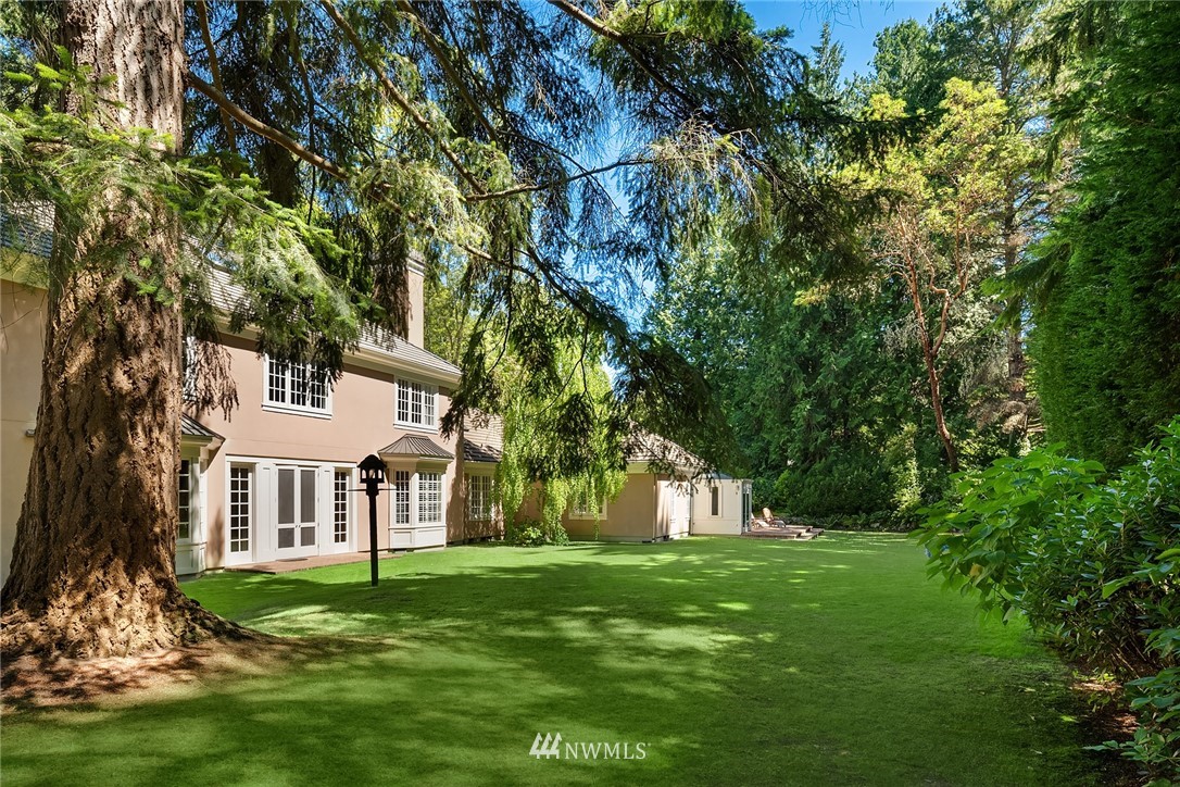 142 Moss Road Shoreline, WA 98177 - Photo 30 of 32 a view of a white house with a big yard and large trees