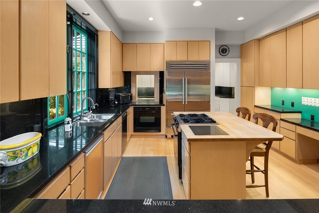 142 Moss Road Shoreline, WA 98177 - Photo 9 of 32 a kitchen with stainless steel appliances granite countertop a sink stove and refrigerator