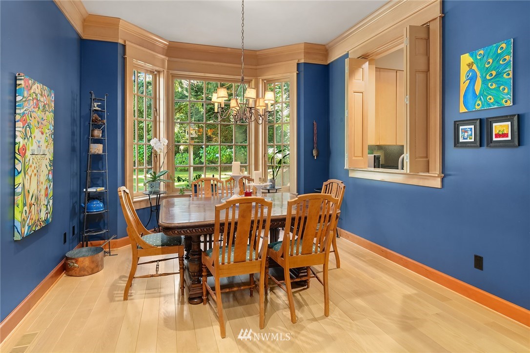 142 Moss Road Shoreline, WA 98177 - Photo 10 of 32 a dining room with furniture a chandelier and wooden floor