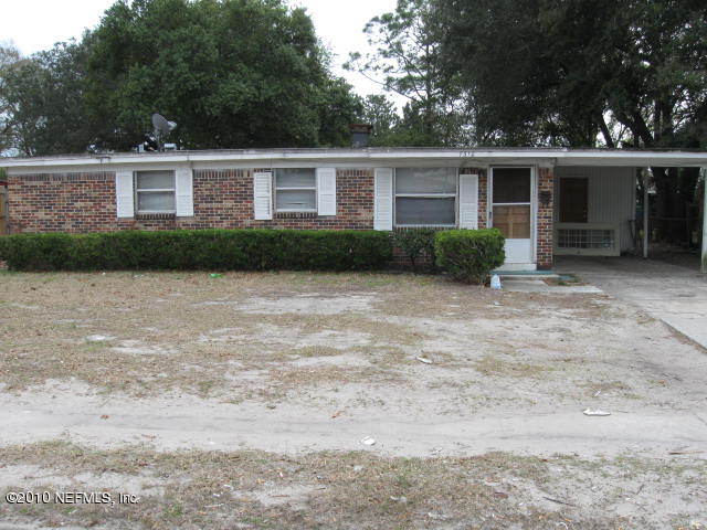 7310 Merrill Road Jacksonville, FL 32277 - Photo 1 of 4 a front view of house with yard and green space