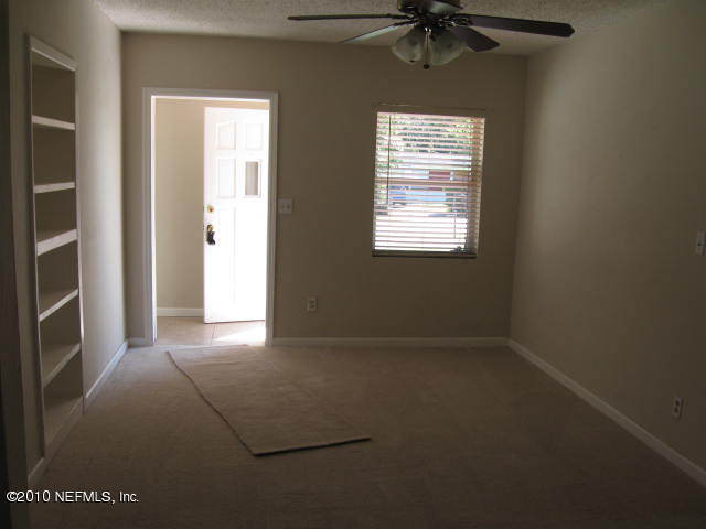 7310 Merrill Road Jacksonville, FL 32277 - Photo 3 of 4 an empty room with a window and a fan