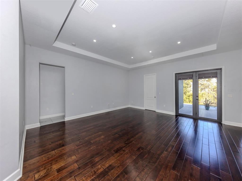 2107 Johannesberg Road North Port, FL 34288 - Photo 15 of 60 a view of an empty room with wooden floor and a window