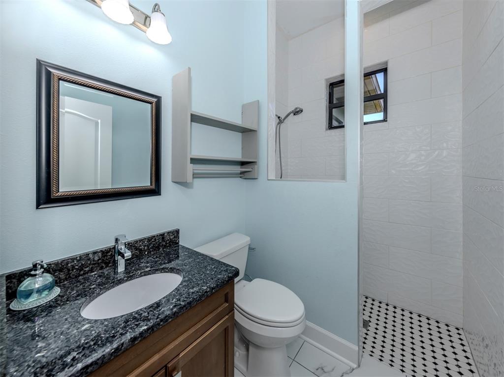 2107 Johannesberg Road North Port, FL 34288 - Photo 16 of 60 a bathroom with a granite countertop sink toilet and mirror
