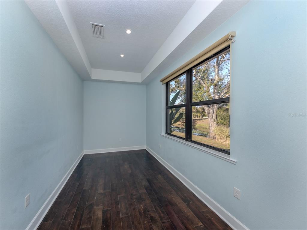 2107 Johannesberg Road North Port, FL 34288 - Photo 18 of 60 an empty room with wooden floor and windows