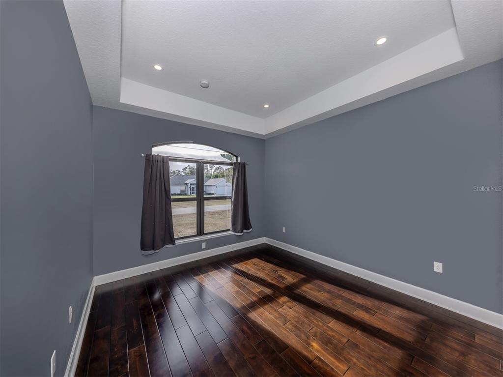 2107 Johannesberg Road North Port, FL 34288 - Photo 20 of 60 a view of an empty room with wooden floor and a window
