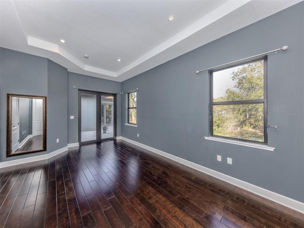 2107 Johannesberg Road North Port, FL 34288 - Photo 23 of 60 a view of an empty room with wooden floor and a window