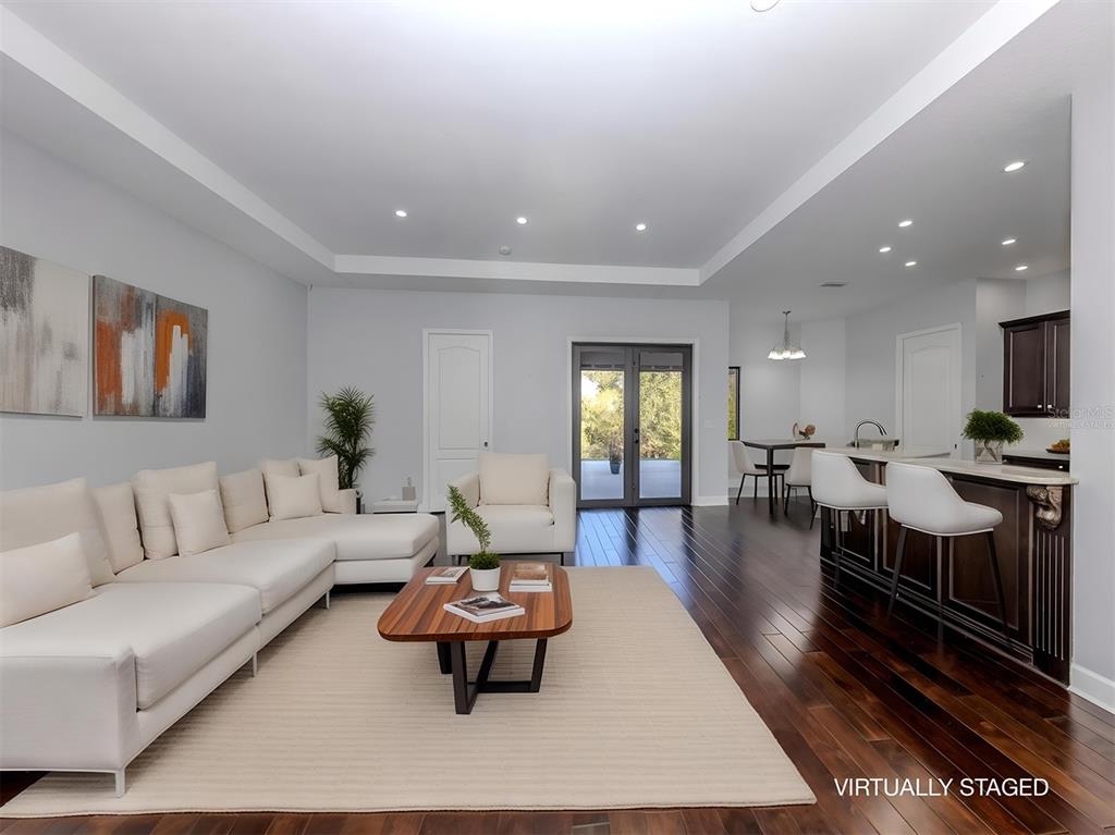 2107 Johannesberg Road North Port, FL 34288 - Photo 3 of 60 a living room with furniture a rug and a table