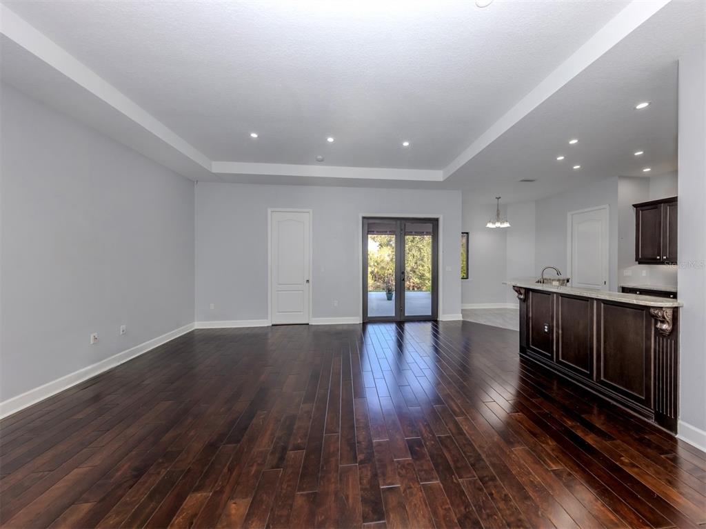 2107 Johannesberg Road North Port, FL 34288 - Photo 4 of 60 a view of an empty room with wooden floor and a window