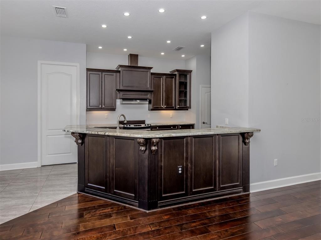 2107 Johannesberg Road North Port, FL 34288 - Photo 6 of 60 a kitchen with a refrigerator and a stove top oven