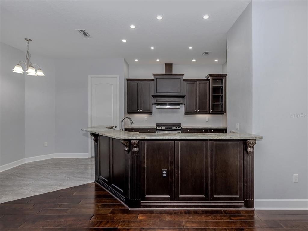 2107 Johannesberg Road North Port, FL 34288 - Photo 7 of 60 a kitchen with stainless steel appliances a sink stove and cabinets