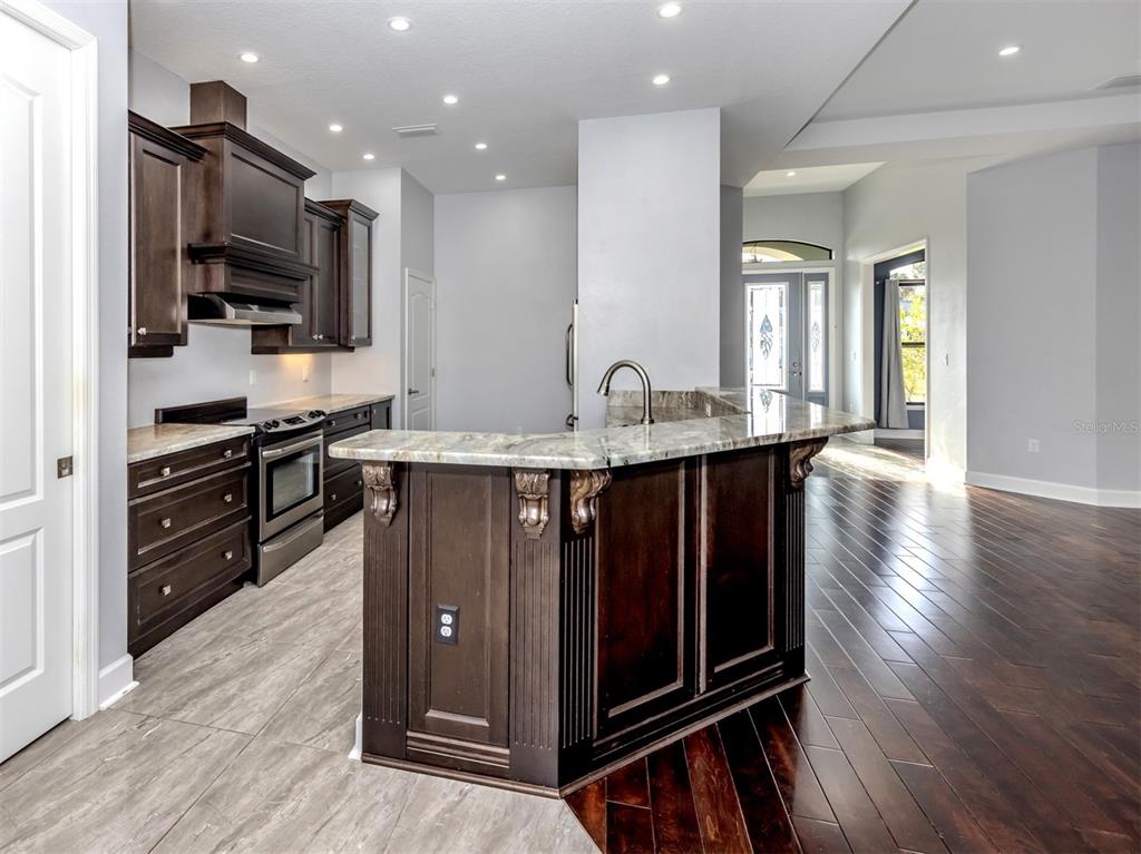 2107 Johannesberg Road North Port, FL 34288 - Photo 8 of 60 a kitchen with stainless steel appliances granite countertop a stove a sink and a microwave