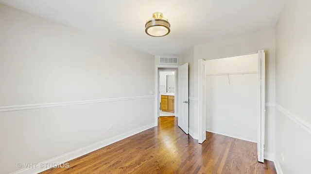 a view of small space with wooden floor and white walls
