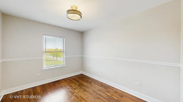 a view of a room with wooden floor and window