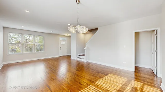 a view of a room with wooden floor and large windows