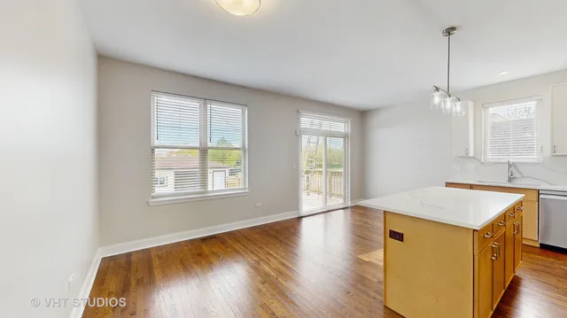 a view of a kitchen and wooden floor