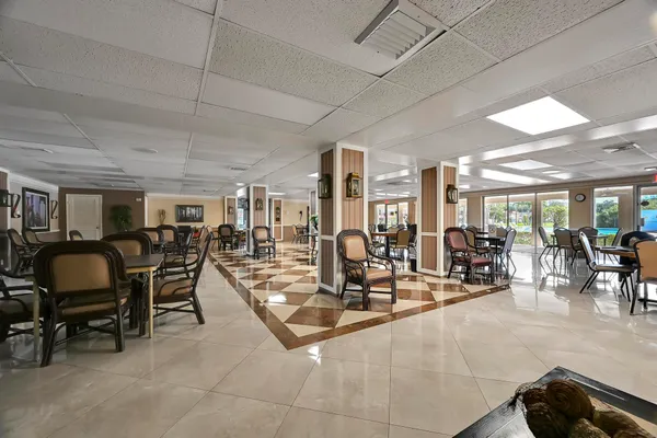 a room with lots of chairs and mirrors