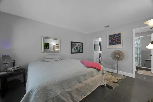 a bedroom with a bed and lamp