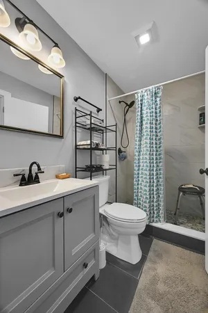 a bathroom with a sink toilet and shower