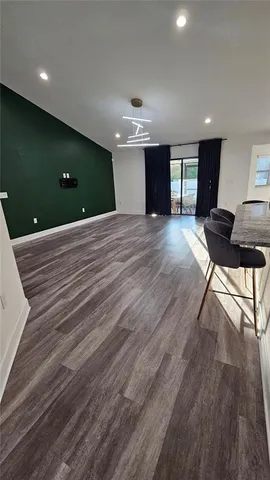 a view of a livingroom with furniture and wooden floor