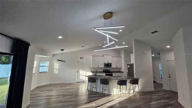 a kitchen with stainless steel appliances kitchen island a refrigerator and a stove top oven