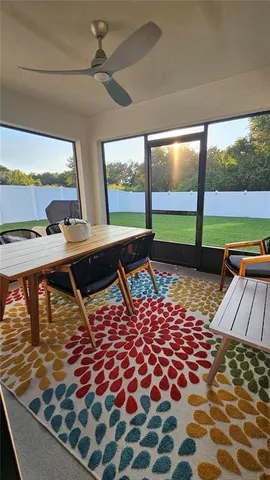 a room with pool table and glass windows