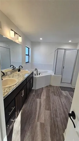 a spacious bathroom with a sink and a large mirror