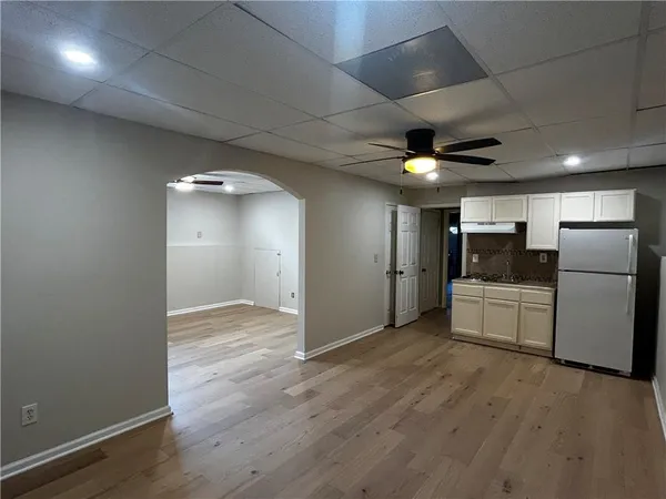 a view of a refrigerator in kitchen and a window