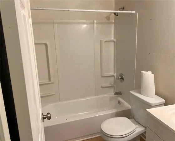 a bathroom with a toilet and a bathtub