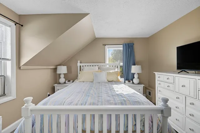 a bedroom with a bed and flat screen tv