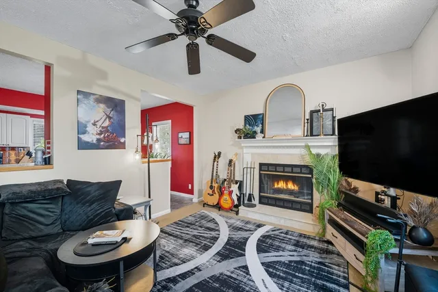 a living room with furniture a flat screen tv and a fireplace