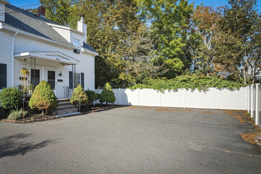 28 R School Street Danvers, MA 01923 - Photo 2 of 31 front view of a house with potted plants and a large tree