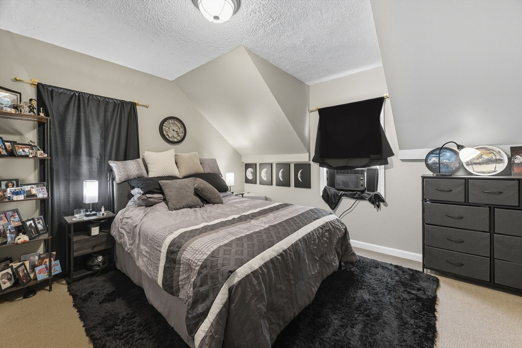 28 R School Street Danvers, MA 01923 - Photo 23 of 31 a bed room with a bed and a television