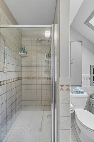 a bathroom with a toilet and shower