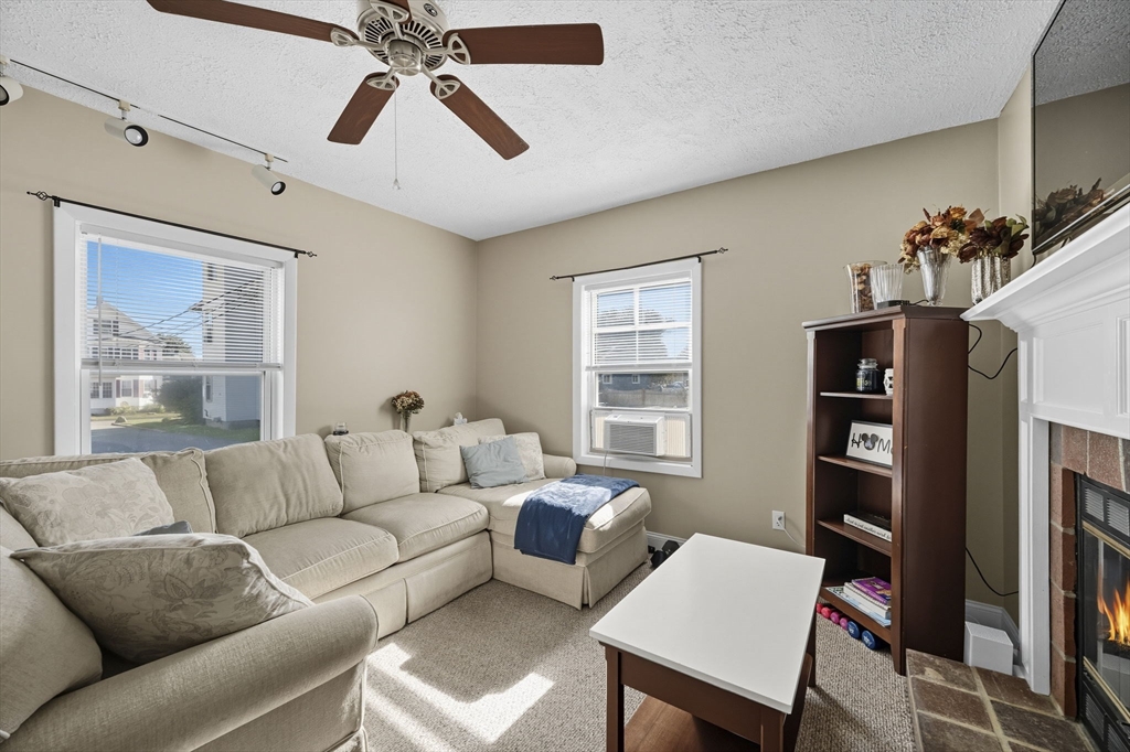 28 R School Street Danvers, MA 01923 - Photo 7 of 31 a living room with furniture a flat screen tv and a large window